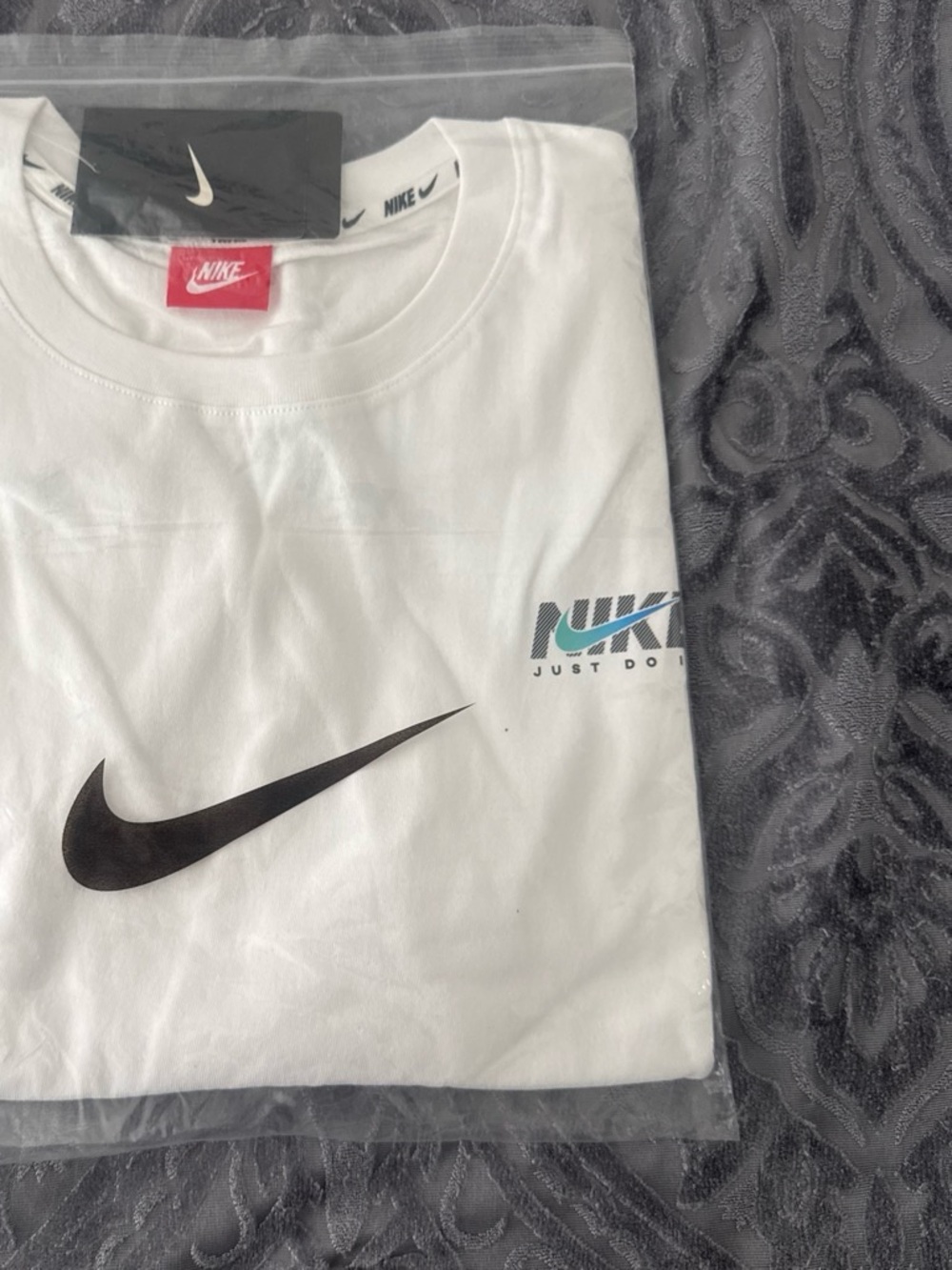 Nike White Short Sleeve T-Shirt with Black Swoosh and Teal Accent